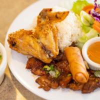 Com Thap Cam (Combo Plate) · Grilled pork chop, fried chicken wing and egg roll.