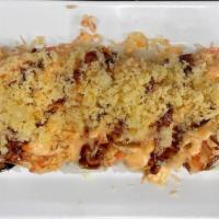 Pyro Roll · Shrimp tempura inside, topped with baked krabmeat, spicy mayo, eel sauce, and crunchy flakes.