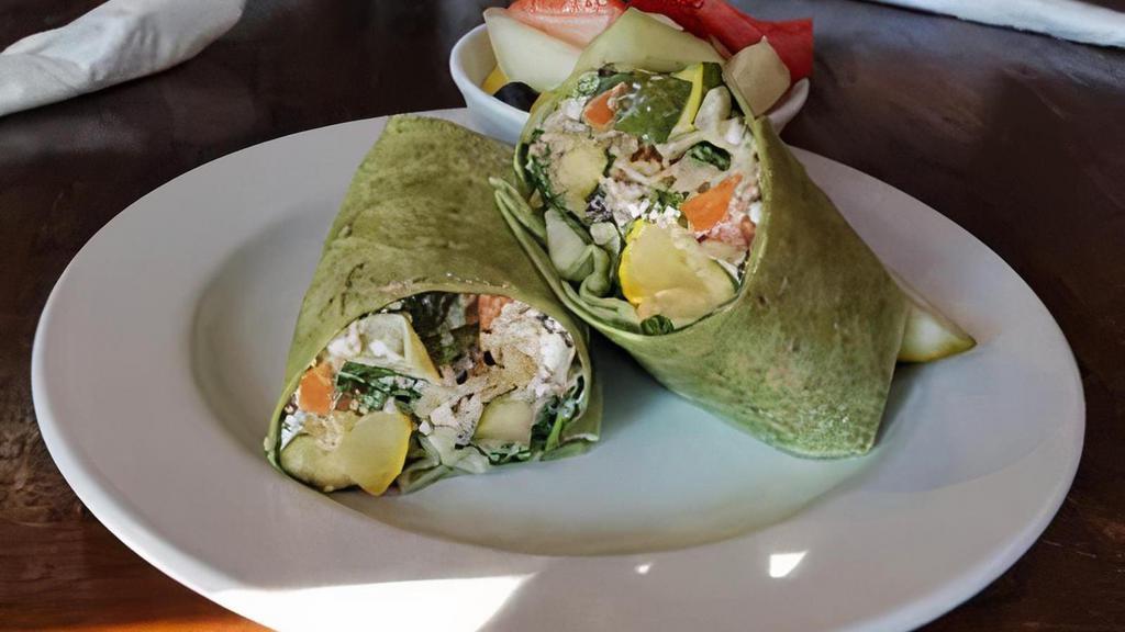 Harvest Wrap · New, vegetarian. Oven-roasted veggies, quinoa, spinach, artichoke hearts, creamy goat cheese, and pecans tossed in our lemon garlic dressing. 670 cal.