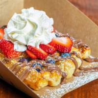Berry Loaded · Original liege waffle, drizzled with nutella, topped with mixed berries and whipped cream