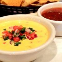 Tostada Chips & Queso · House-made queso and salsa served with warm tostada chips.