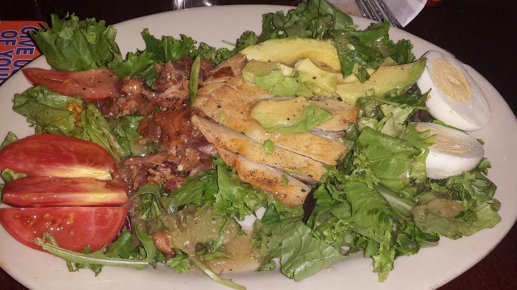 Cobb Salad · Mixed greens topped with marinated chicken breast, tomatoes, avocado, hard-boiled egg, sliced avocado, bleu cheese crumbles, and applewood smoked bacon.  Choice of dressing.