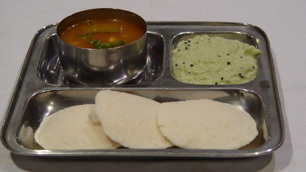 Idly · Vegetarian, gluten-free. Steamed lentil and rice cakes served with sambar and coconut chutney.