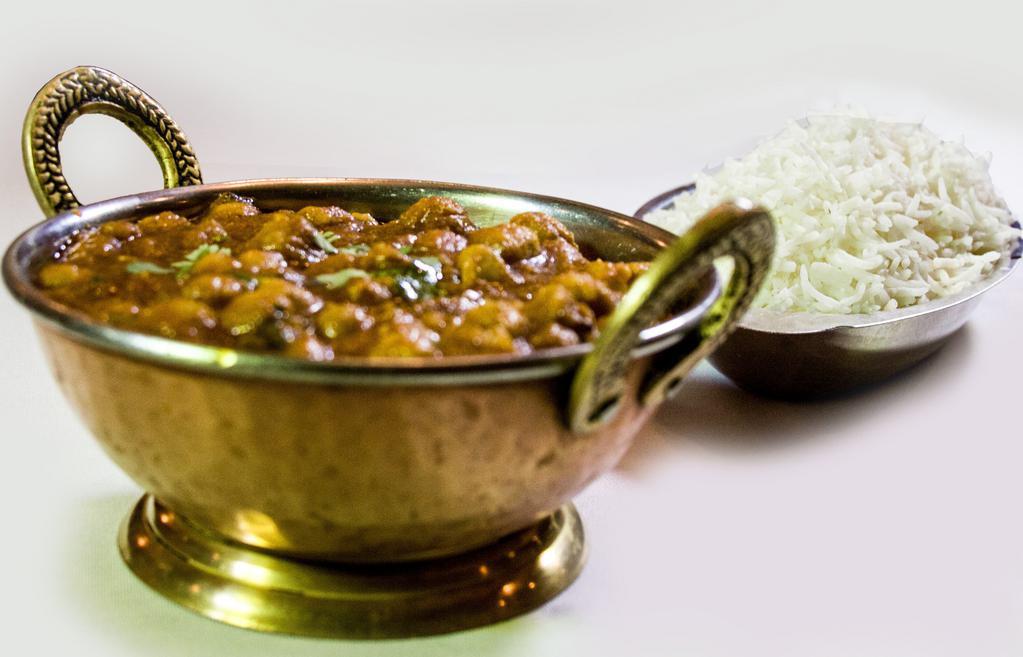 Chana Masala · Vegetarian, gluten-free. Chickpeas cooked with onions and fresh tomato sauce with exotic spices.