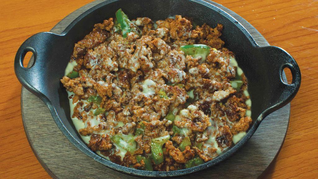 Choriqueso · New! Served on a hot skillet. Cheese sauce mixed with chorizo (Mexican sausage) and fresh diced green peppers. Our homemade Mexican sausage is very lean, using all fresh ingredients, with no preservatives added.