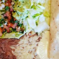 Steak Burrito · Topped with cheese dip.