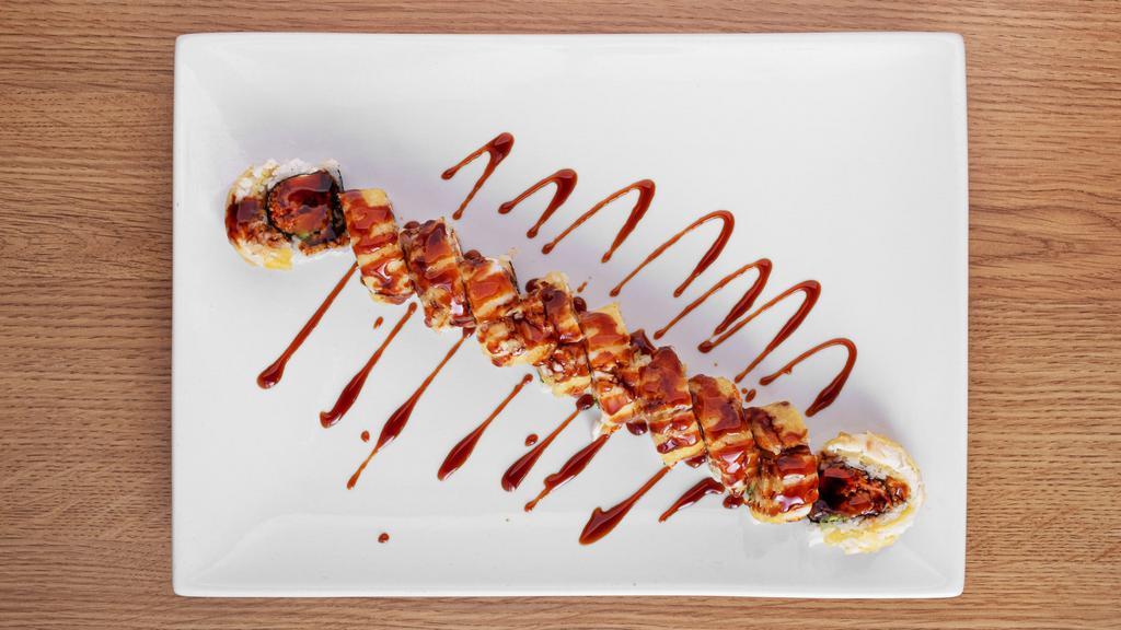 Godzilla Roll · 10 Pieces
In: eel, spicy crab, masago, avocado and cream cheese
Out: deep fried red snapper w/ eel sauce