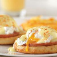 Eggs Benedict · 2 poached eggs atop an English muffin & Canadian Bacon topped with hollandaise sauce and ser...