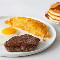Ham Steak & Eggs · Grilled Ham Steak with 2 eggs, choice of hash browns or grits & 3 fluffy pancakes