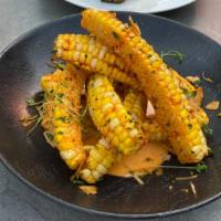 Elote · Gluten free. Sweet corn smothered and baked in habanero and Carolina reaper aioli tossed in ...