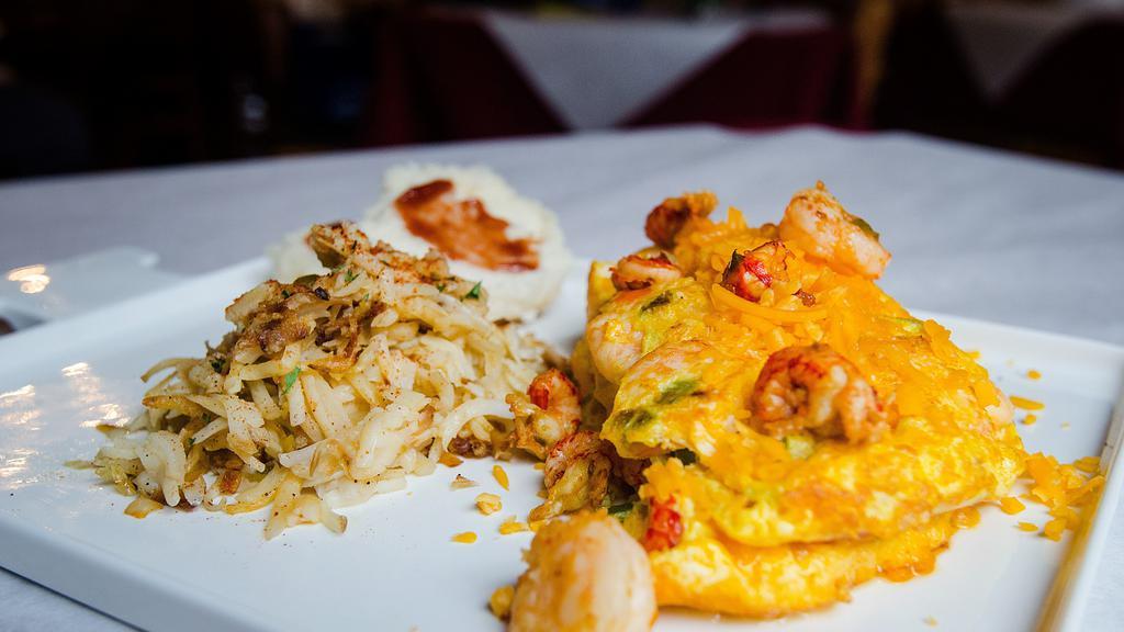Seafood Omelette · Crawfish, shrimp, mushrooms, green onions, bell peppers and cheddar cheese. Served with hash browns and a biscuit.