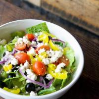Greek Salad · Romaine lettuce topped with banana peppers, black olives, red onions, grape tomatoes, and fe...