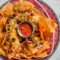 Macho Nachos · Com tortillas smothered with homemade chili, mixed cheeses, refried beans, and topped with b...