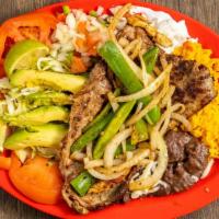 Carne Asada · Thinly sliced grilled steak topped with
grilled onions and jalapeños with
black refried bean...