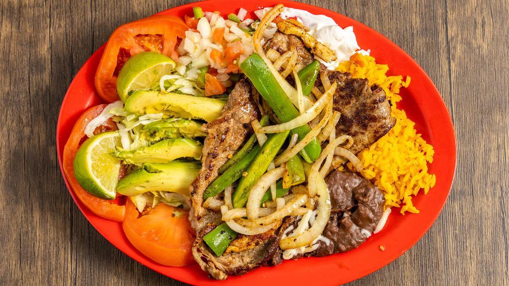 Carne Asada · Thinly sliced grilled steak topped with
grilled onions and jalapeños with
black refried beans, rice, lettuce, tomatoes,
pico de gallo, sour cream & avocado on
the side. Served with your choice of flour or corn tortillas.