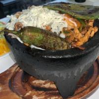 Molcajete Mix · Sizzling fajitas with chicken, steak, shrimp
and Mexican sausage cooked with cactus,
bell pe...