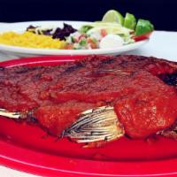 Mojarra Al Chipotle · Whole fried tilapia topped with a special spicy chipotle sauce. Served with salad, rice, bea...