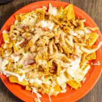 Nachos · Nacho chips topped with your choice of meat, lettuce, tomatoes, cheese dip, Mexican cheese, ...