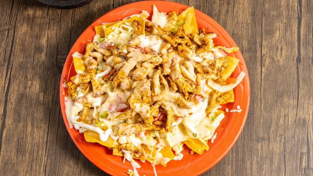 Nachos · Nacho chips topped with your choice of meat, lettuce, tomatoes, cheese dip, Mexican cheese, sour cream, cilantro, pico de gallo, guacamole and jalapeños.