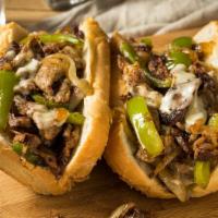 The Classic Philly Cheesesteak Sandwich · Delicious Philly steak sandwich loaded with grilled steak and melted cheese on a toasted hoa...