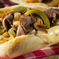 The Steak Sandwich · Delicious Philly steak sandwich loaded with grilled steak and onions on a toasted Amoroso's ...