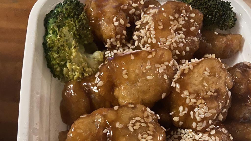 Sesame Chicken · Chunks of chicken sautéed in sweet sauce, with sesame toppings, served with broccoli on the side.