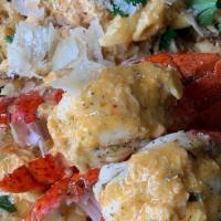 Cajun Seafood Pasta · Creamy Cajun alfredo loaded w/ shrimp, salmon, lump crab, & lobster tails. Side of garlic br...