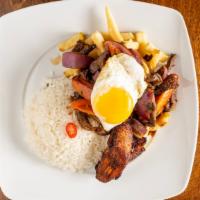 Lomo Saltado A Lo Pobre · The most popular Peruvian dish lean strips of beef sautéed with bright tomatoes and onions i...