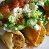 Taquitos Dorados · Rolled up tortillas deep fried and filled with your favorite protein. Topped with queso fres...