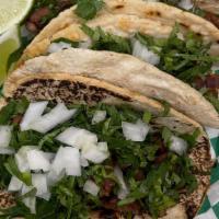 Tacos · Classic street tacos made with homemade tortillas and topped with onion, cilantro and your f...