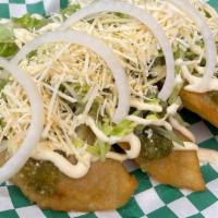 Empanada · Fried dough filled with your protein of choice:  topped with queso fresco, cream (crema fres...