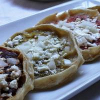 Picadita Veracruzana · Homemade tortilla filled with queso fresco, cream (crema fresca), lettuce, onion, tomato and...