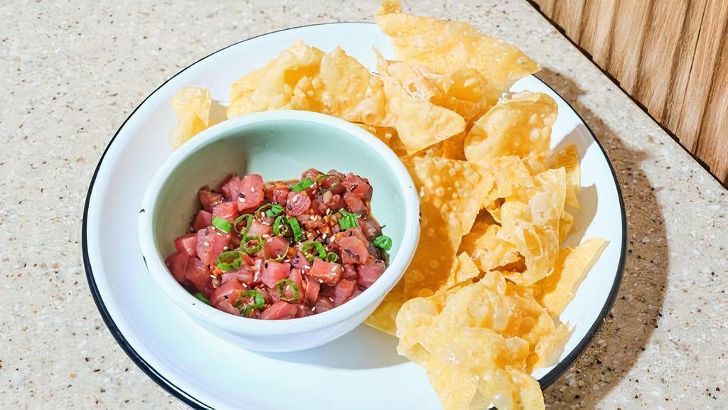 Tuna Crisps · tuna bites, tataki sauce, sesame seeds, green onion, side of fried wonton chips