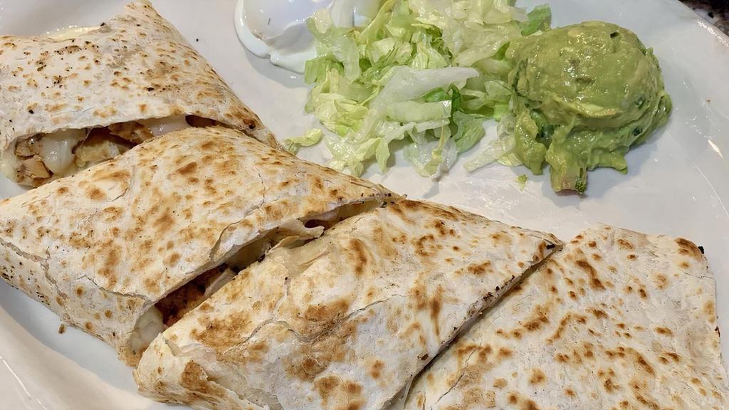 Quesadillas · On flour tortillas with rice, and beans on the side.