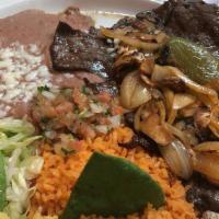 Carne Asada · Served with refried beans, lettuce, pico de gallo, avocado, and corn tortillas.