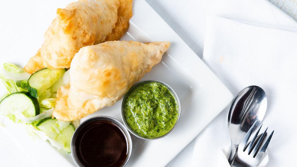 Veg Samosa (3 Pcs) · Crispy fried Indian pastry shell with a savory filling of spiced potatoes and peas.