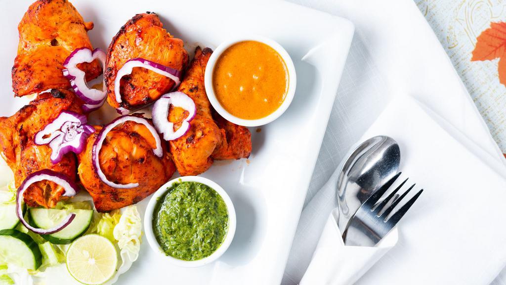 Chicken Tikka · Chicken cubes marinated overnight with yogurt and spices then baked in tandoor.