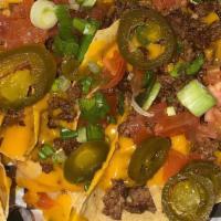 Deluxe Nachos · Topped with cheese, jalapeños, diced tomatoes, green onions & sour cream Add: Taco Beef for ...