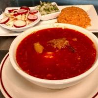 Menudo · Beef tripe soup.  Served with shredded cabbage, cilantro and onions, radishes, lime wedges a...