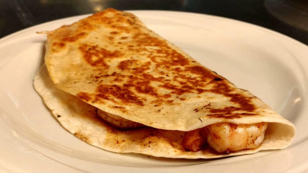 Shrimp Quesadilla · A flour tortilla grilled and stuffed with fresh grilled shrimp, cheese, onions, bell peppers and tomatoes. Served with Spanish rice, lettuce, sour cream and guacamole.