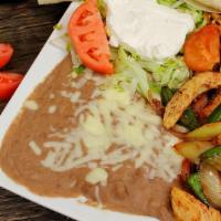 Fajita Express · Steak or chicken grilled with peppers, onions, and tomatoes. Served with beans, lettuce, sou...