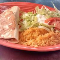 Shrimp Quesadilla · Grilled flour tortilla stuffed with shrimp, cheese, and beans. Served with rice and crema sa...