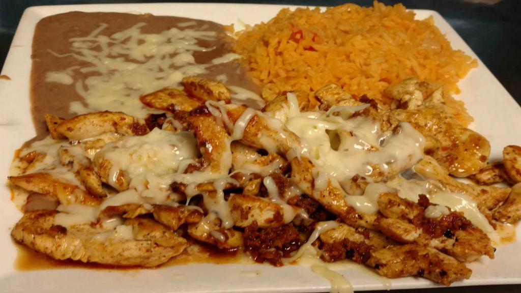 Chori Pollo · Grilled chicken and chorizo topped with cheese dip. Served with rice, beans, and tortillas.