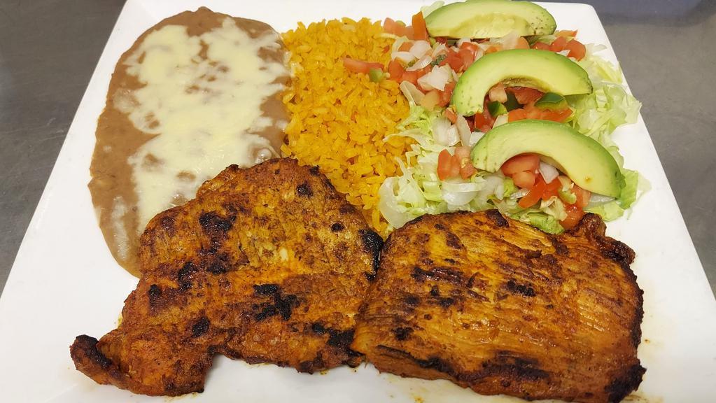  Carne Adobada · Add Guacamole for an additional charges.
Thinly sliced marinated pork.  Served with Spanish rice, refried beans, lettuce, pico de gallo, sliced avocado and tortillas.