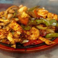  Texas Fajitas · Steak, chicken and shrimp grilled with onions, peppers and tomatoes.