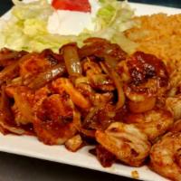 Camarones A La Diabla · Shrimp and grilled onions sauteed in our own diabla salsa. Served with rice, crema salad, an...