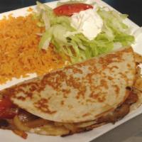 Quesadilla Rellena · Flour tortilla grilled and stuffed with mushrooms, onions, tomatoes, beans, and cheese. Serv...