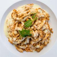 Arroz Con Pollo · A bed of rice with slices of chicken breast marinated in achiote red seed, with cheese dip o...