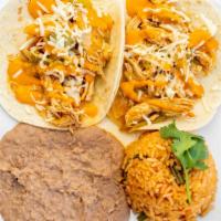 Tinga Tacos · Two flour tortillas with shredded chicken, cheese, and corn chipotle sauce. Served with pint...