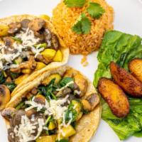 Tacos Vegetarianos · Two corn tacos stuffed with zucchini, squash, mushrooms, spinach, and beans sauce. Served wi...